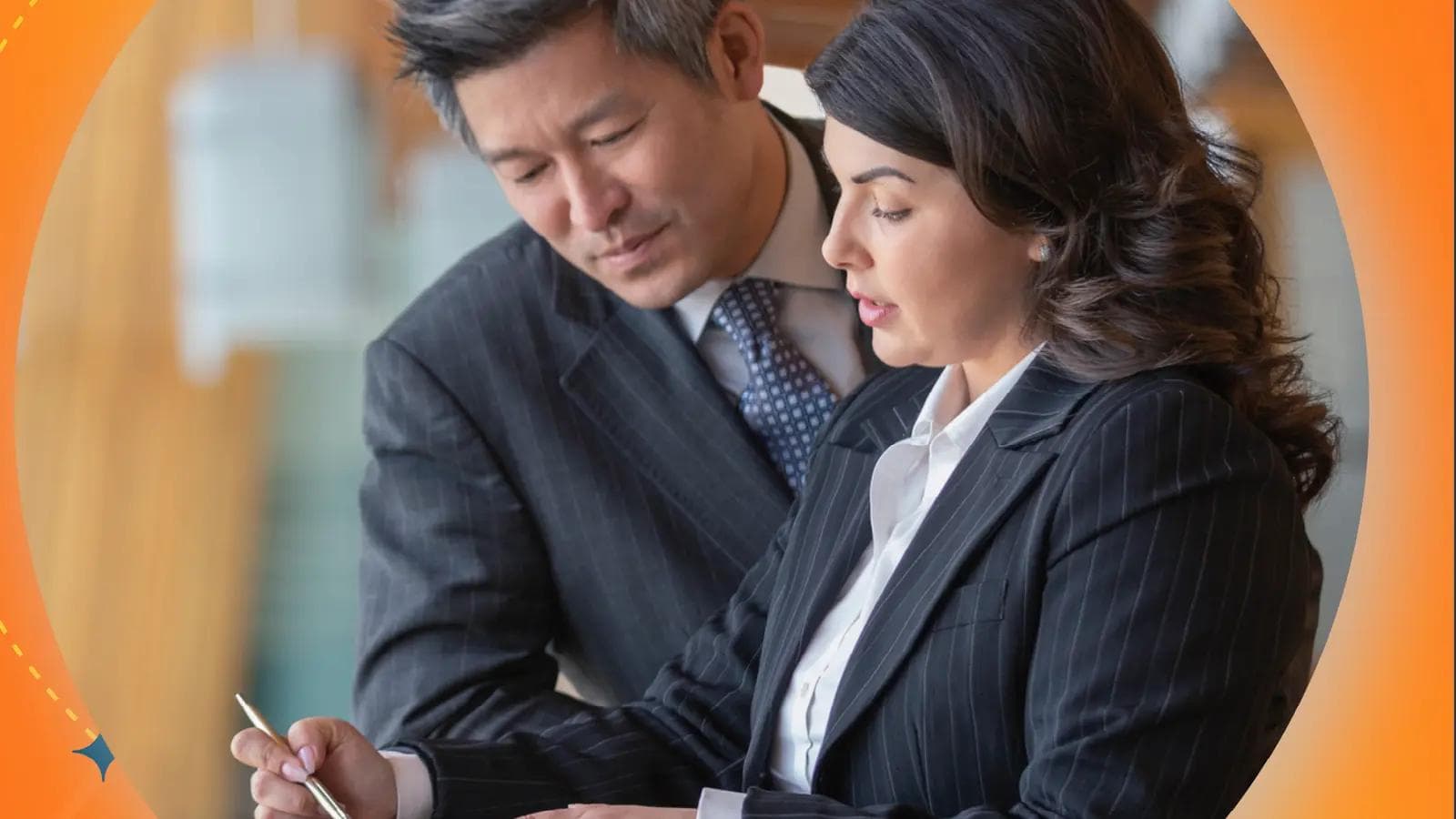 Image of two government workers reviewing a document together.
