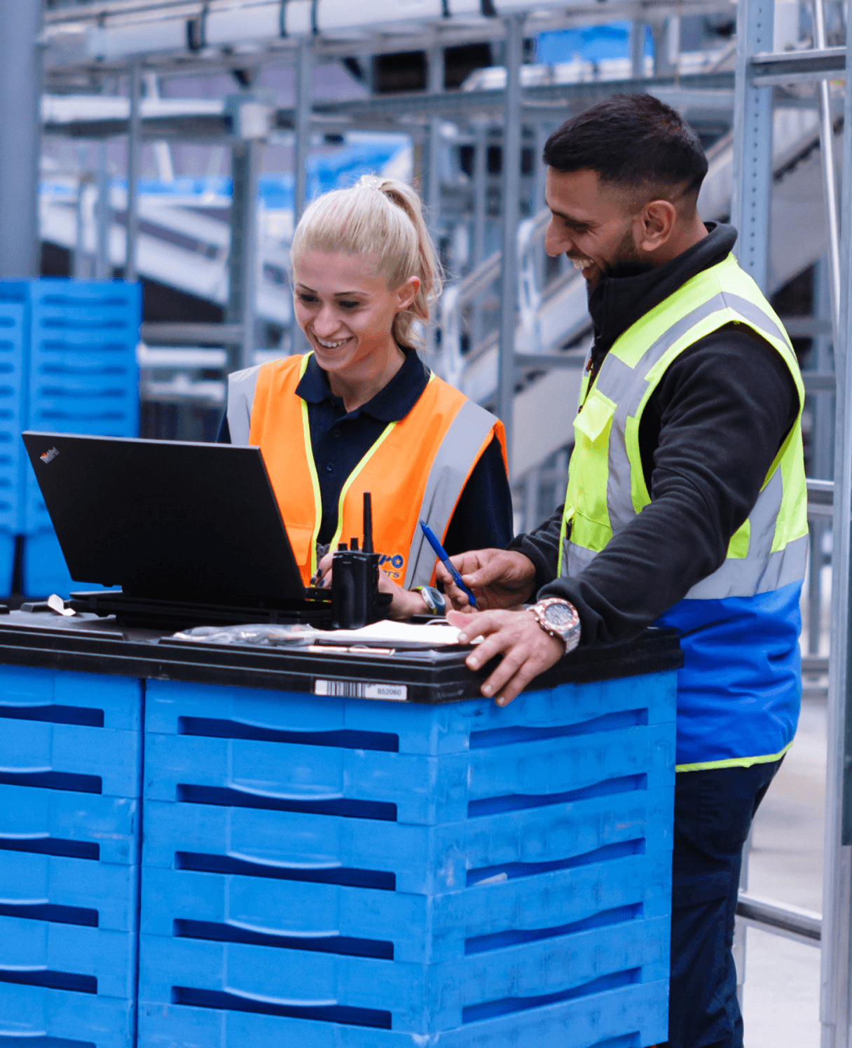 a man and a woman are looking at a laptop