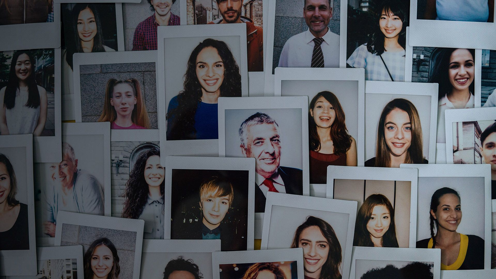 Polaroid photos of various men and women.