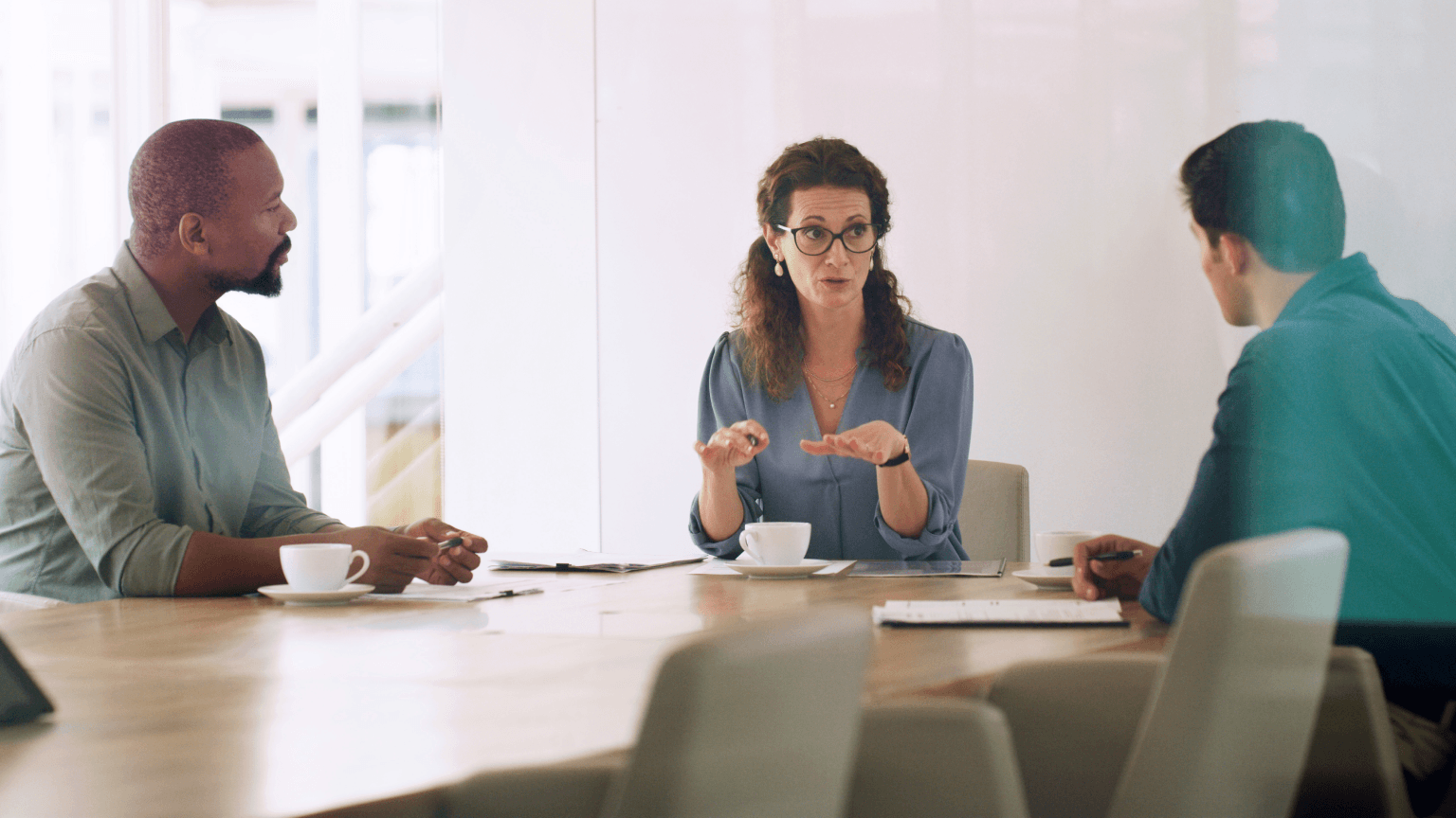 Image of three people working in an office.
